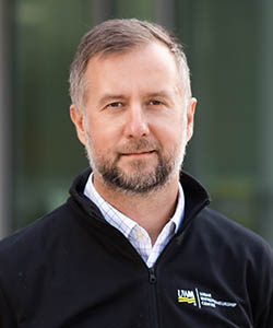 Bearded man in UWM logowear
