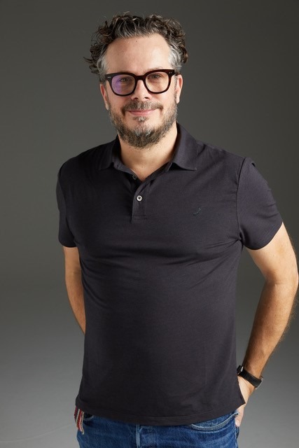 Man in black polo shirt wearing glasses
