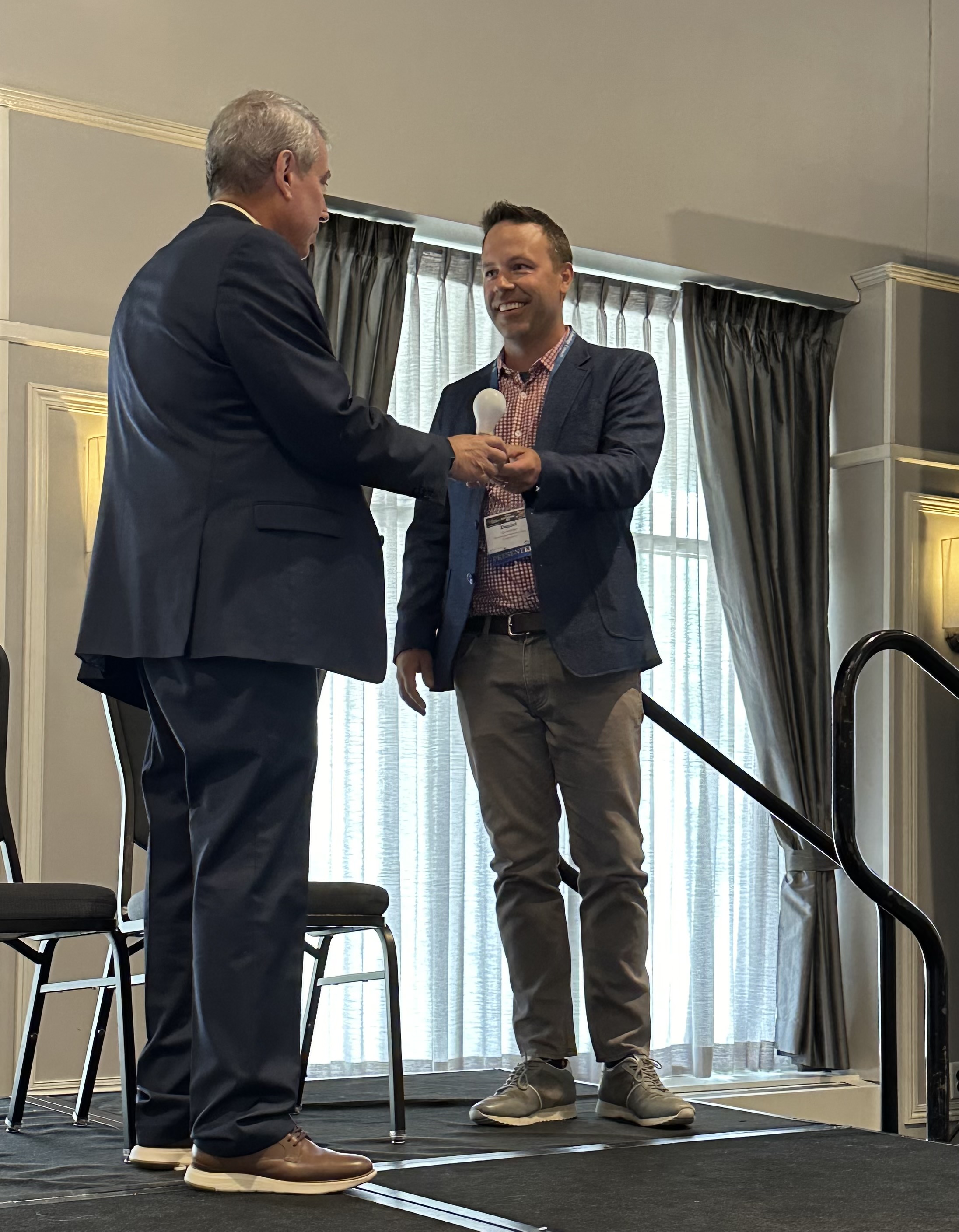 Man on stage getting an award.