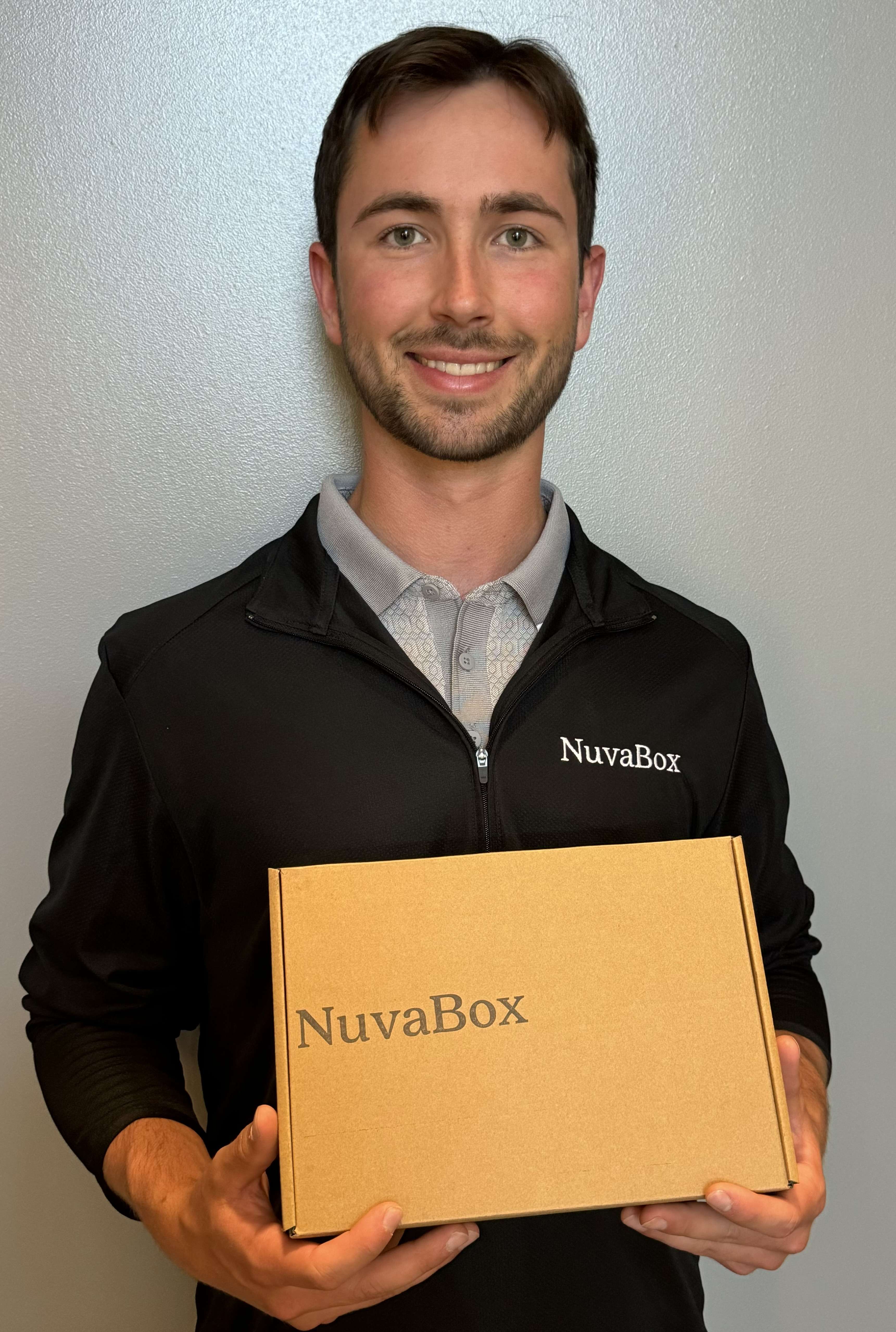 Man holding box with NuvaBox logo.