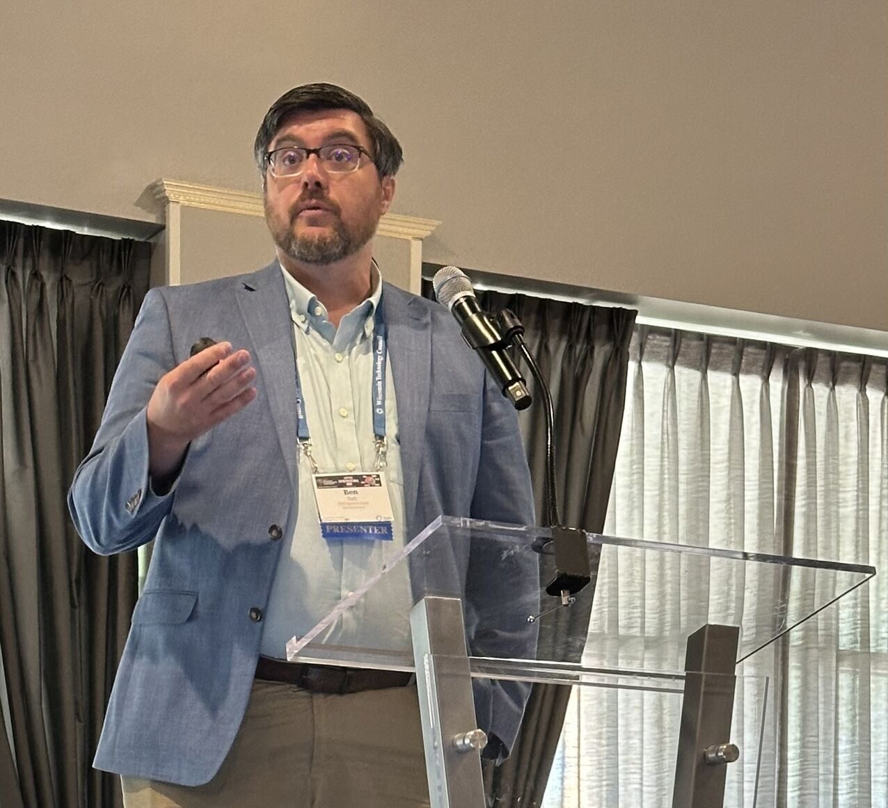 Man on stage behind podium.
