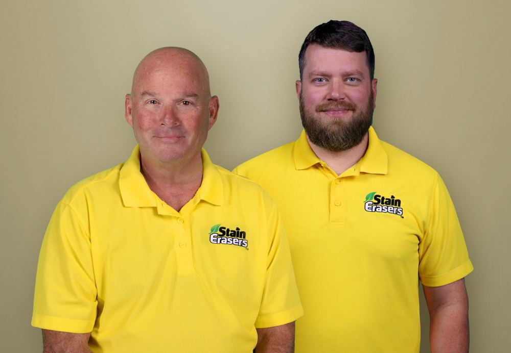 Two men in yellow polo shirts